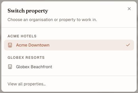 The Switch property dialog, listing Acme Hotels with Acme Downtown ticked as current, Globex Resorts with Globex Beachfront, and a View all properties link