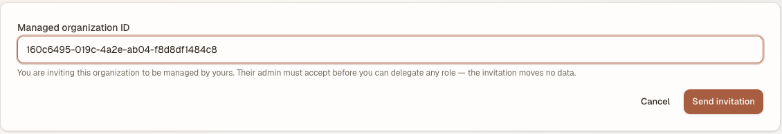 The invite form with a managed organisation id pasted in, above the note that their admin must accept and that the invitation moves no data