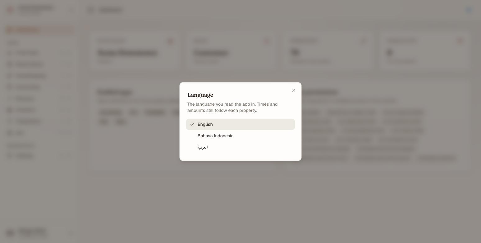 The Language dialog in Nerve, opened from the account menu. It is headed Language, explains that times and amounts still follow each property, and lists English, Bahasa Indonesia and العربية — each written in its own language — with a tick against English