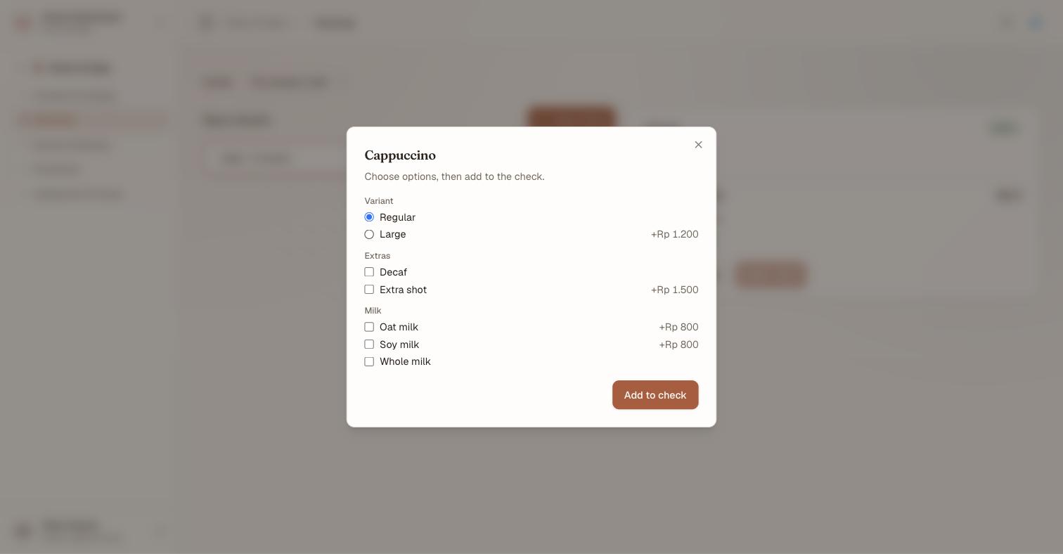 The POS terminal's option picker for a Cappuccino: a Variant radio group with Regular selected and Large at plus Rp 1,200, then Extras and Milk checkbox groups offering Decaf, Extra shot, Oat milk, Soy milk and Whole milk with their price deltas, above an Add to check button